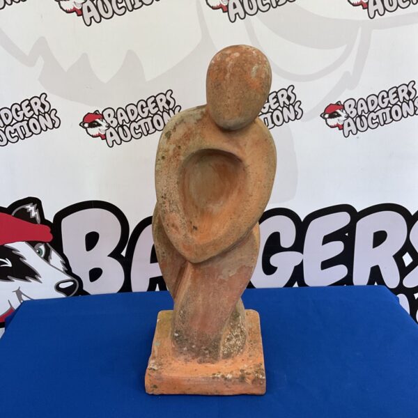 Abstract terracotta sculpture in the style of Henry Moore.