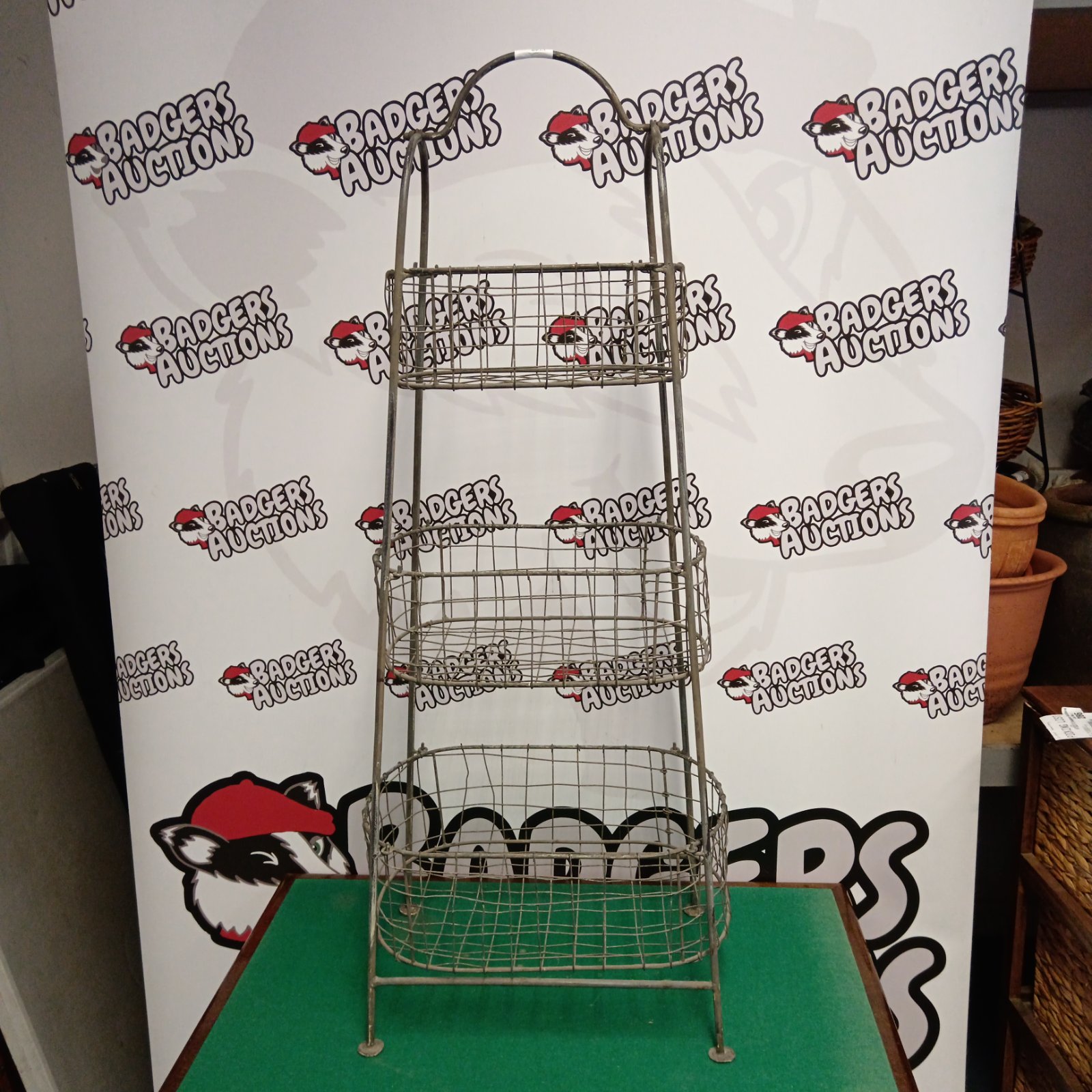 Vintage three tier galvanized metal vegetable basket for kitchen storage.