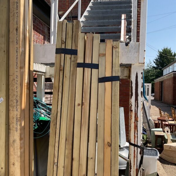 Three bundles of 8ft timber planks for construction projects.