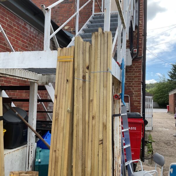 Garden view of three bundles of timber awaiting use.