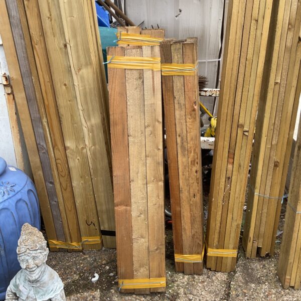 Three bundles of timber stored outdoors, ready for DIY projects.