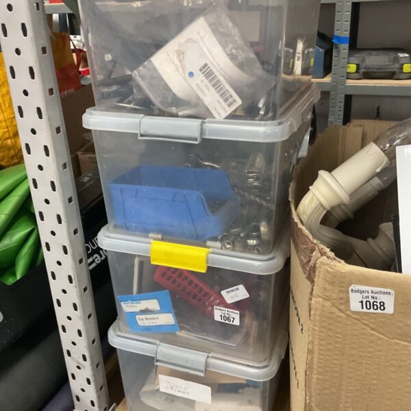 Stack of clear plastic tool storage boxes for workshop organisation.