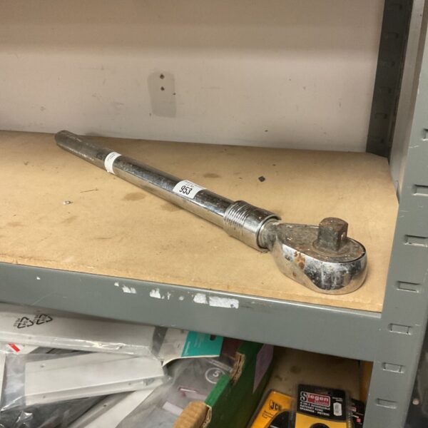 Heavy-duty torque wrench with a long handle for mechanic's work.