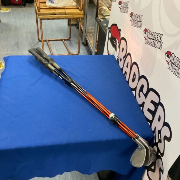Set of training golf clubs for practice and skill development.