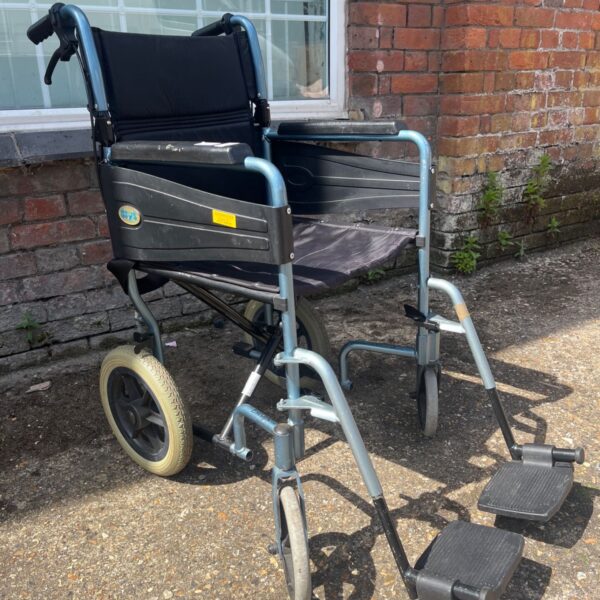 Blue transit wheelchair with footrests, ideal for assisted mobility.