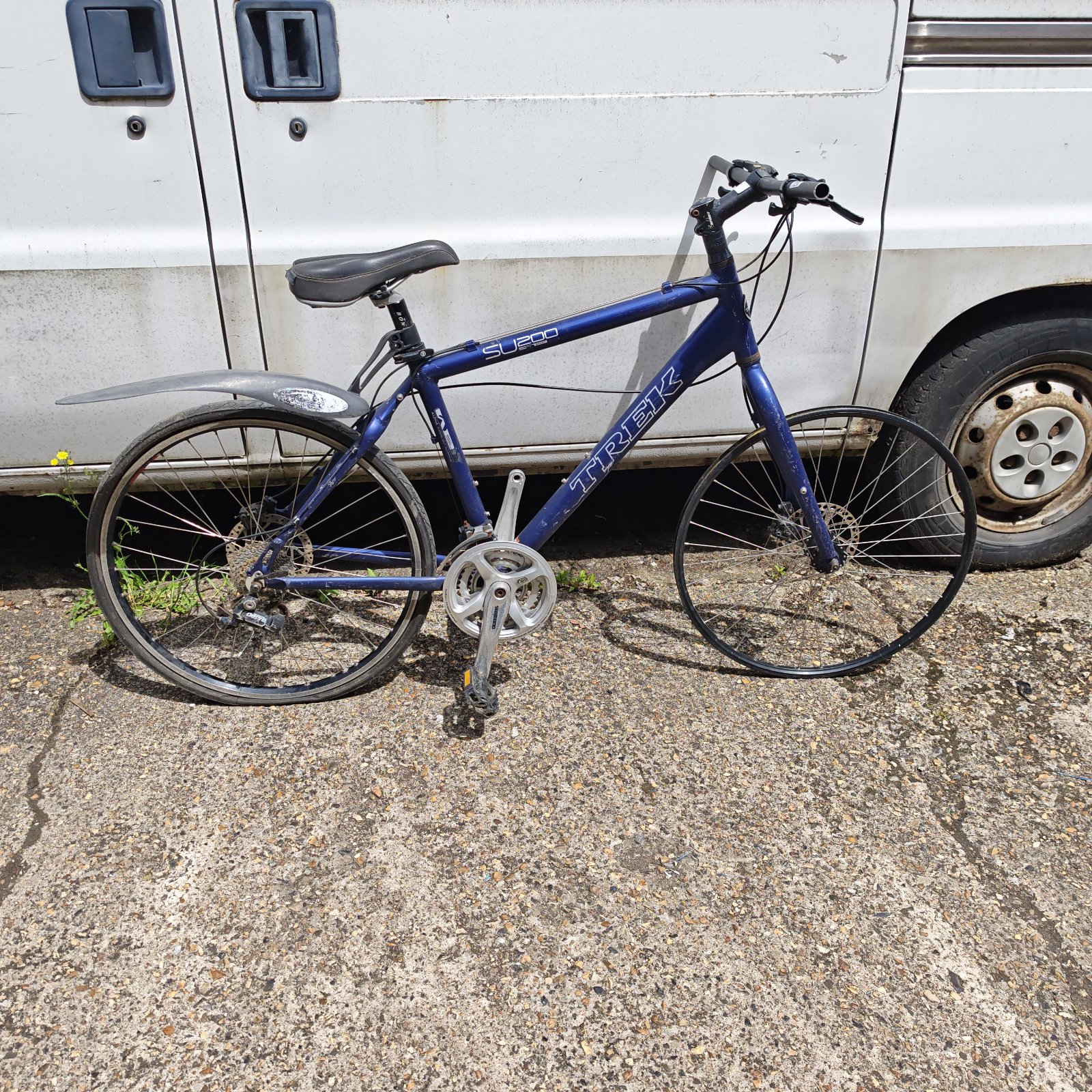 Blue Trek SU200 bicycle needing repair and restoration.