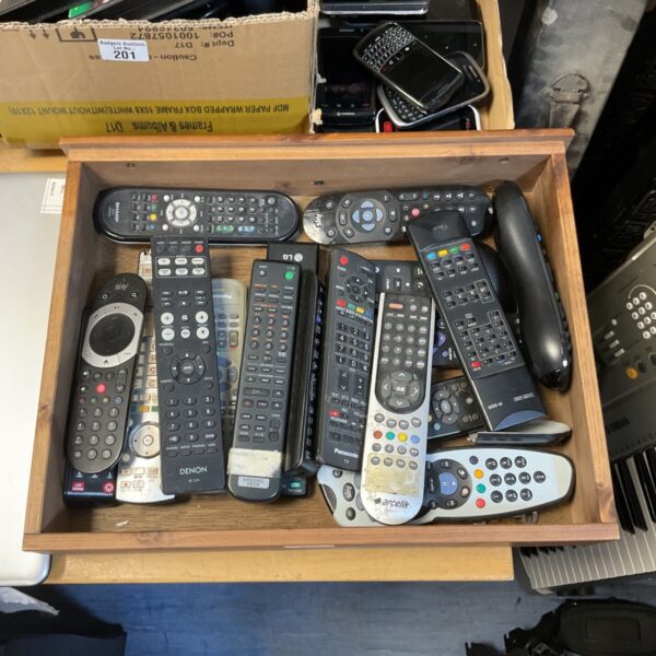 Mixed lot of TV remote controls from various brands.