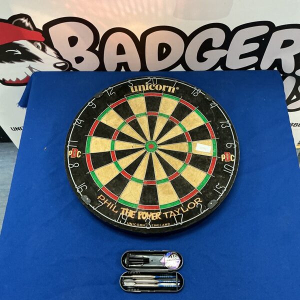 Vintage Unicorn darts board with darts, a classic pub game.