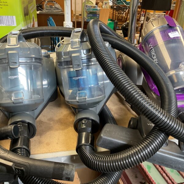 Lot of three cylinder vacuum cleaners including Amazon Basics and Vytronix.