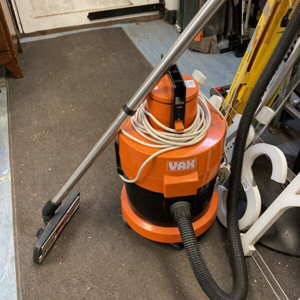Orange Vax model 121 vacuum cleaner with hose and floor brush.