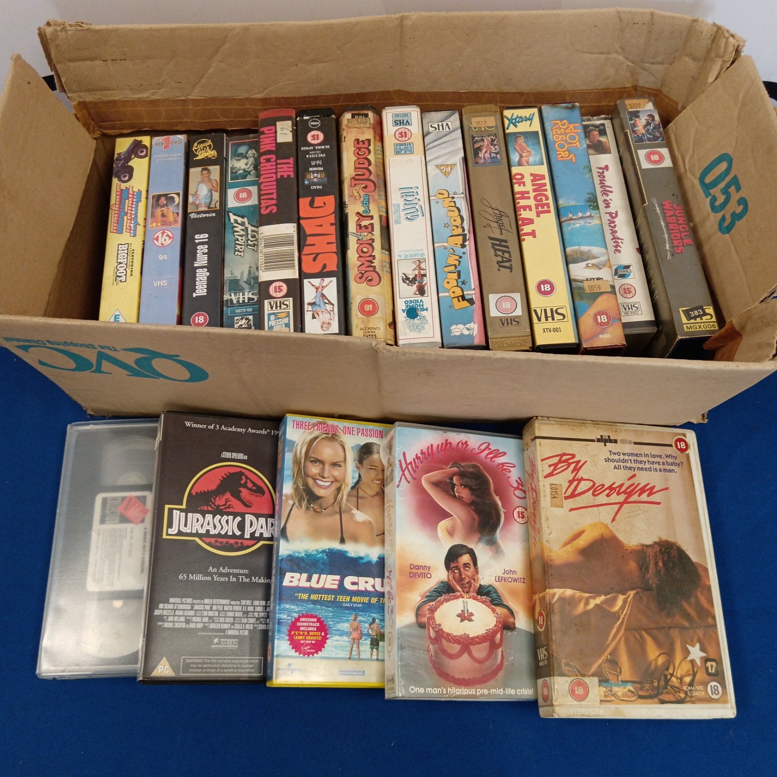 Vintage VHS cassette tape lot including adult movies.