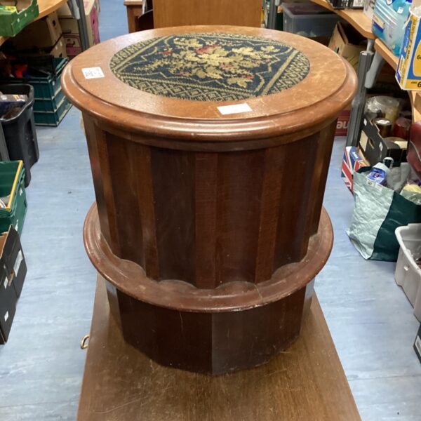 Antique Victorian barrel commode with patterned upholstery.