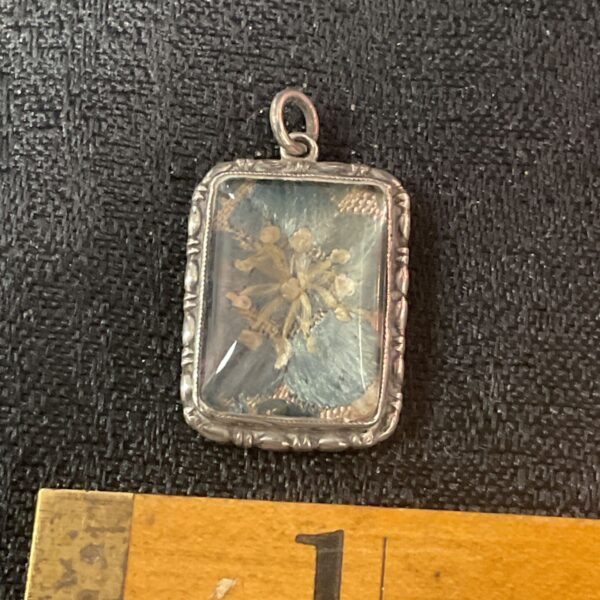 Antique Victorian silver pendant with a preserved butterfly wing.