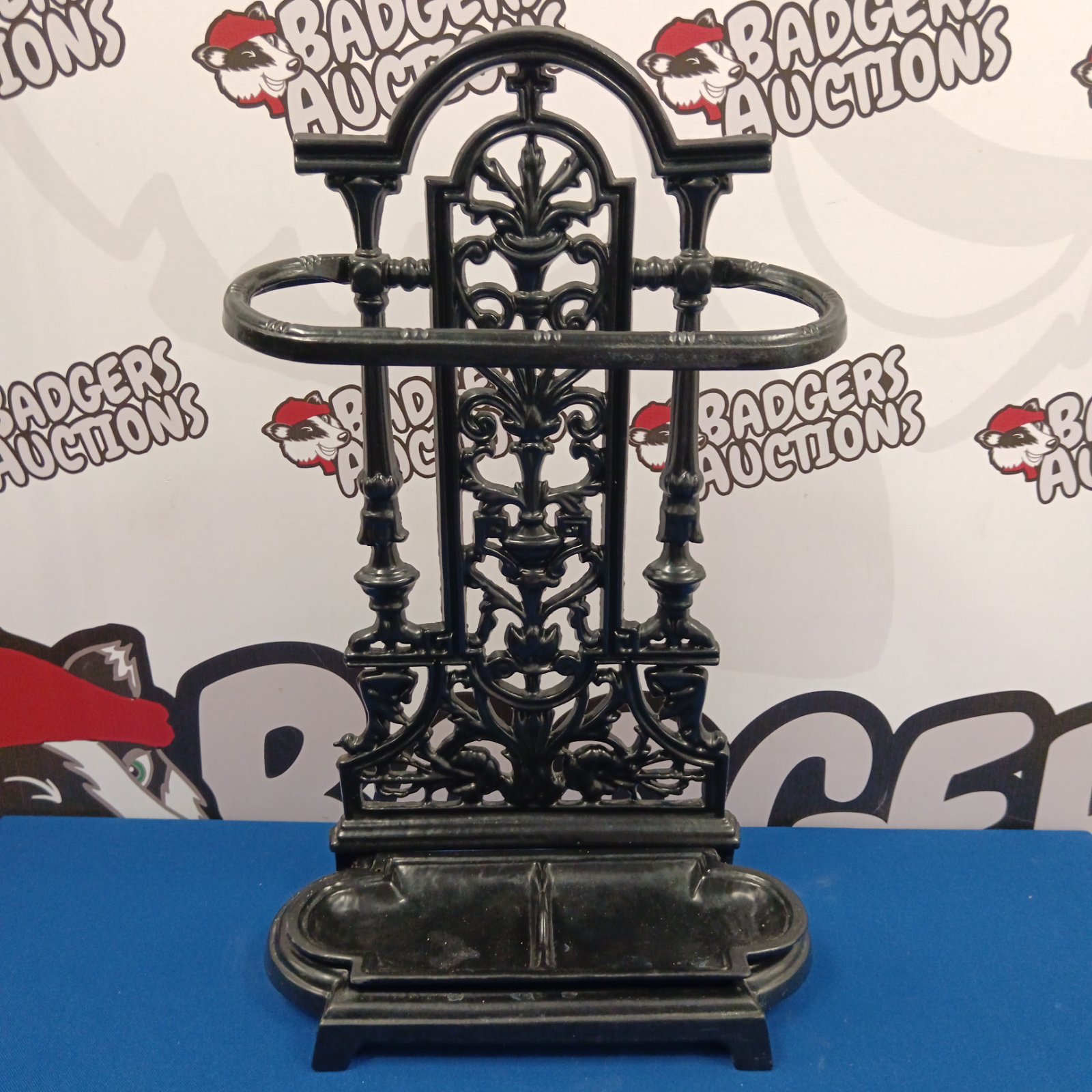 Ornate Victorian cast iron stick and umbrella stand with drip tray.