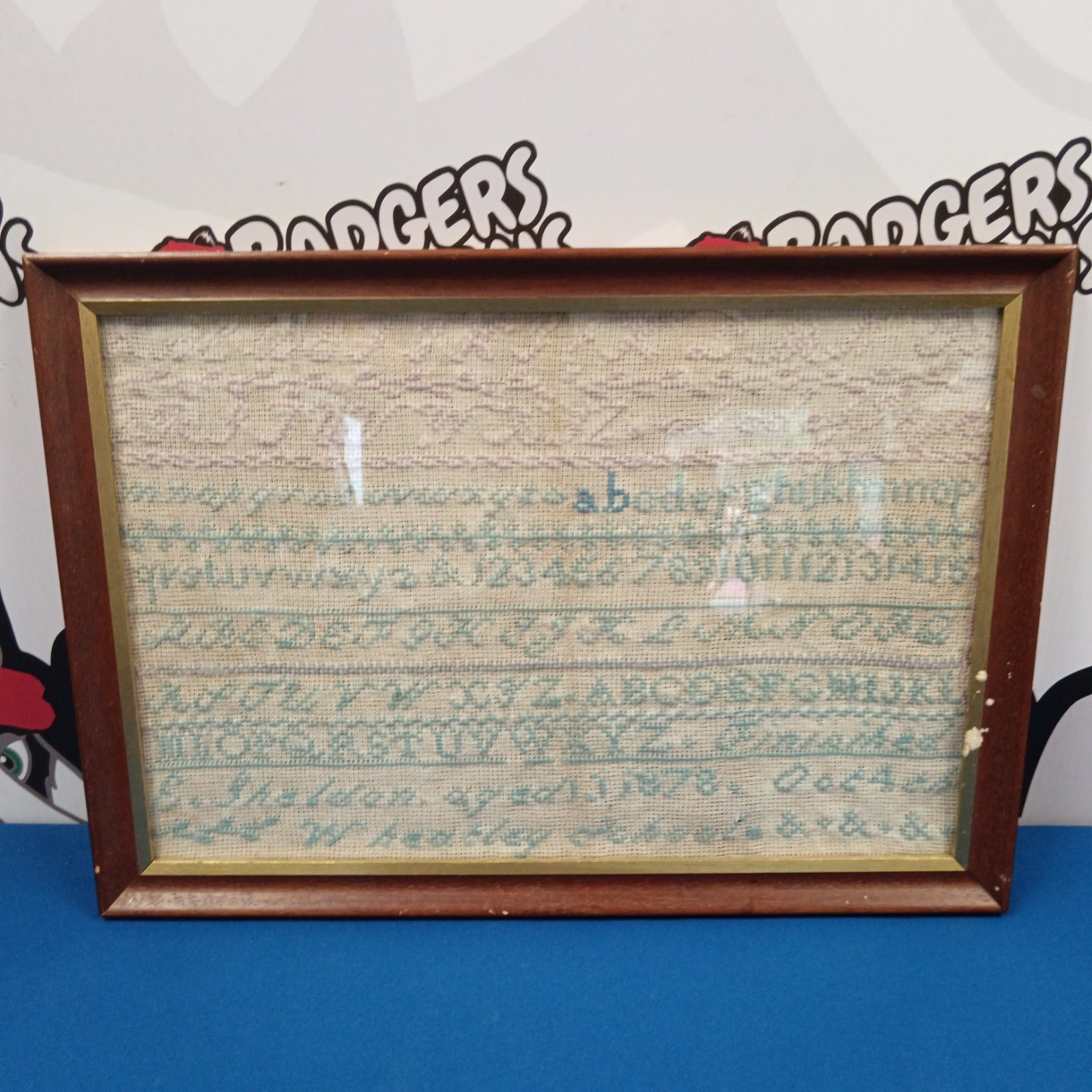Antique 1878 Victorian embroidery sampler with detailed needlework.