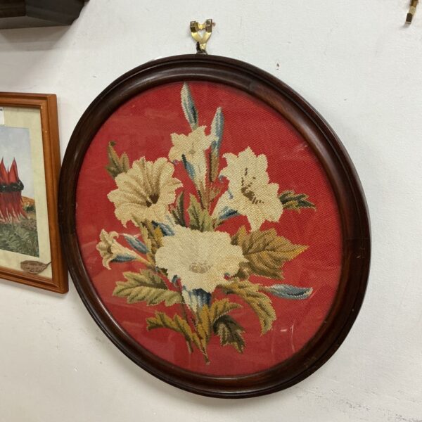Victorian floral embroidery in a round oak frame, antique needlework.