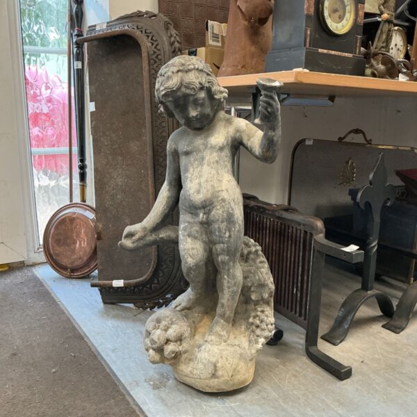 Victorian lead garden cherub statue with fruit detail.