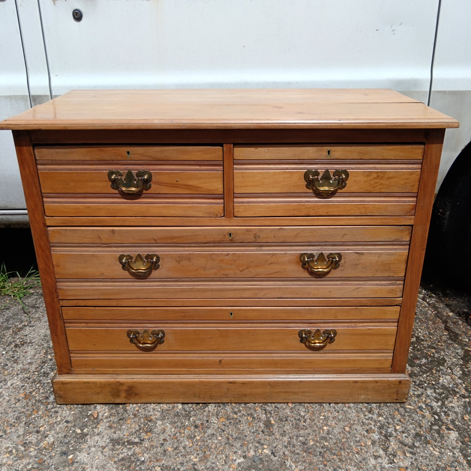 Late Victorian satin walnut chest of drawers with brass handles.
