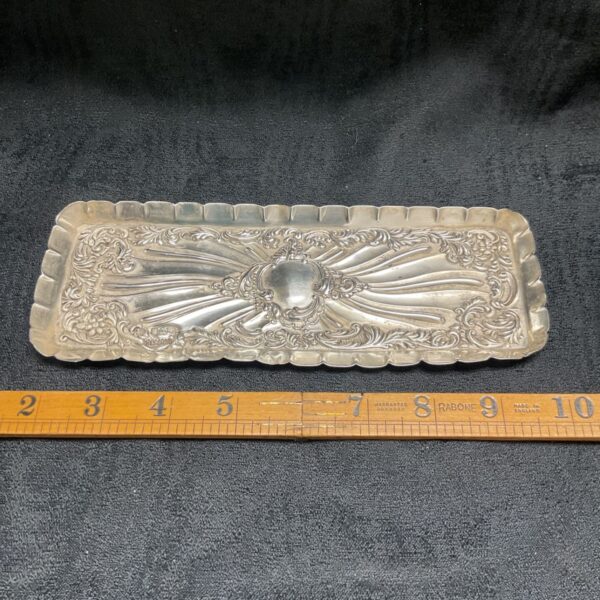 Victorian silver pin tray with floral embossed design.