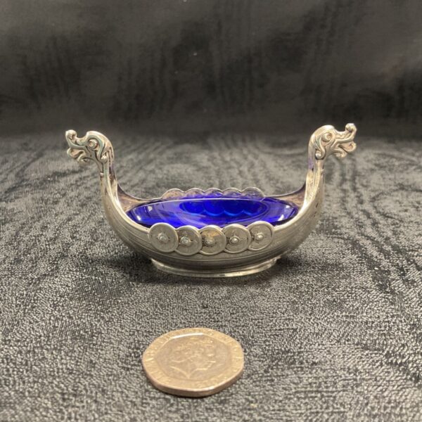Silver Viking ship salt cellar with blue glass liner.