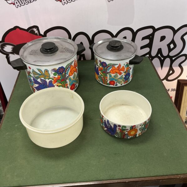 Vintage 1970s cooking pans with colourful floral designs.