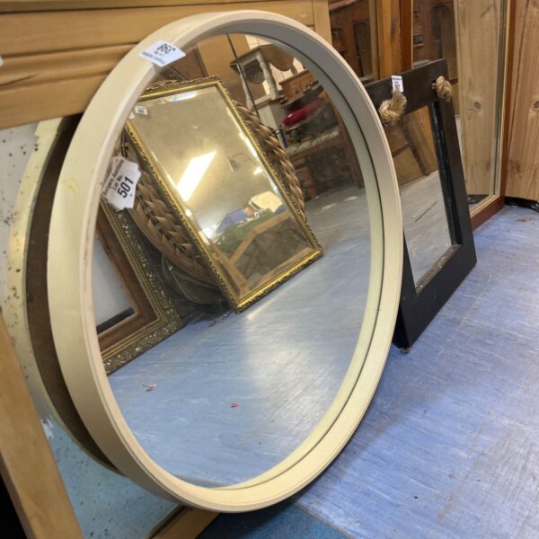 Vintage 1970s cream plastic mirror with a space age design.