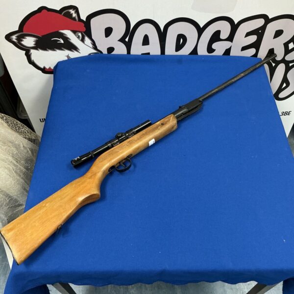 Vintage air rifle with relic scope, a collectible antique airgun.
