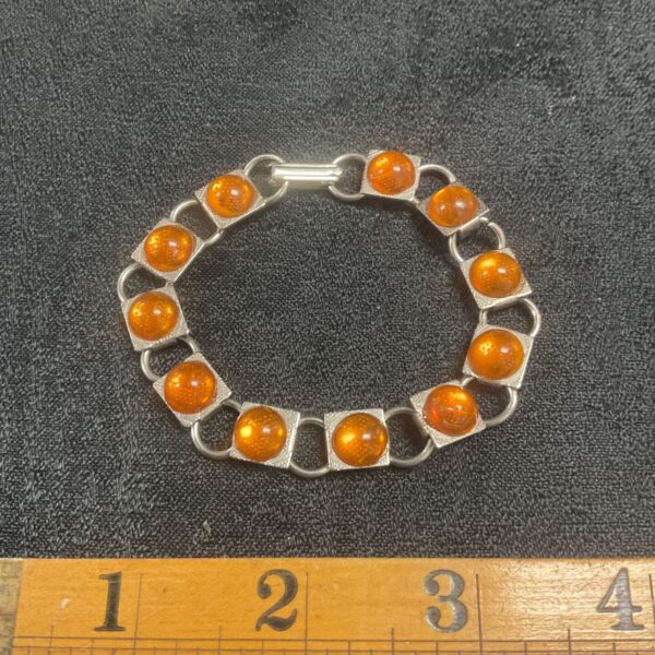 Vintage modernist bracelet with amber cabochons in silver tone.