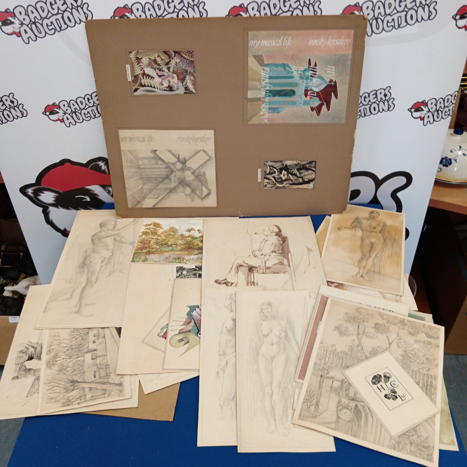 Vintage artist portfolio with nude figure sketches and drawings.