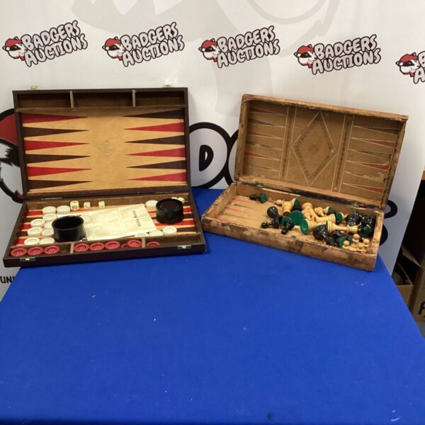 Vintage backgammon and chess sets displayed against a backdrop.