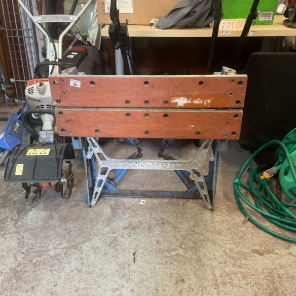 Vintage Black and Decker Workmate portable workbench in a workshop setting.