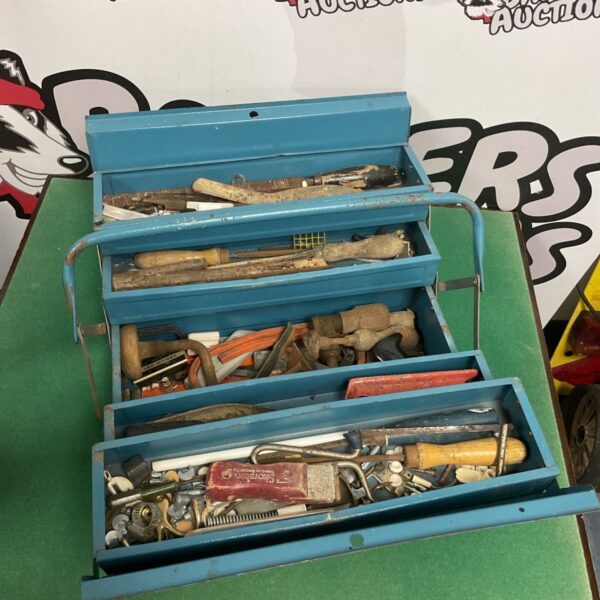 Vintage blue metal toolbox filled with various tools.