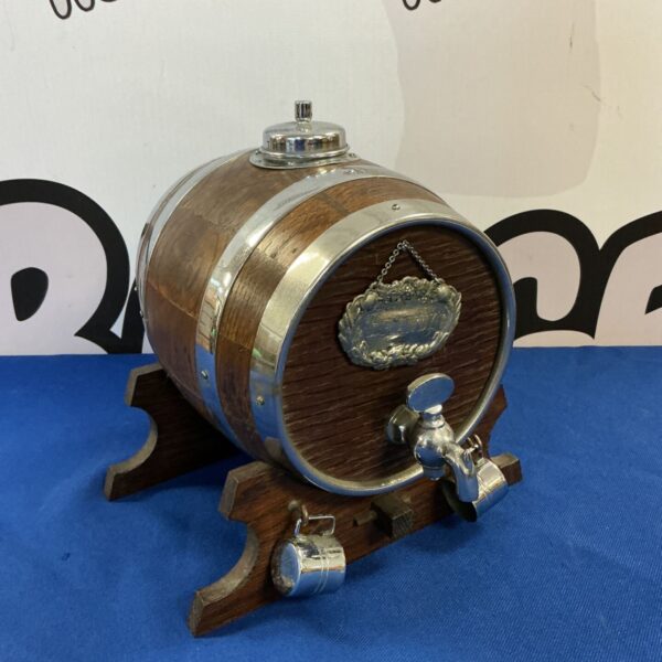 Vintage oak brandy barrel decanter with metal tap.