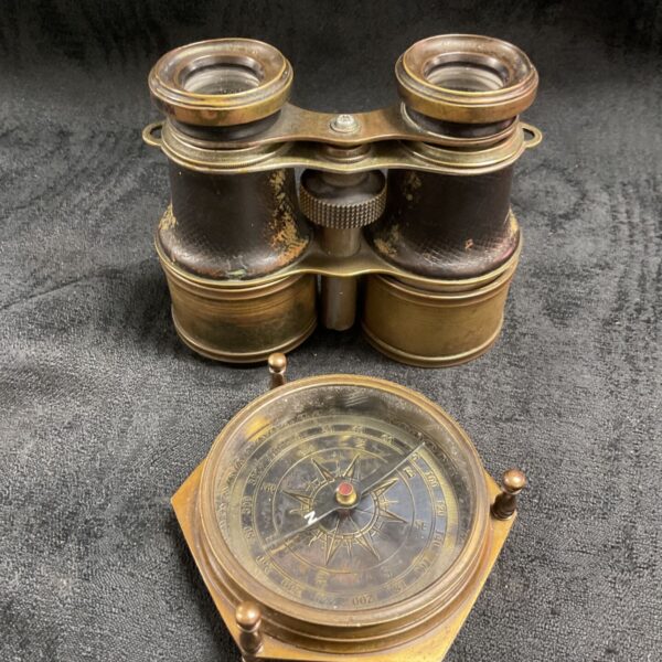 Vintage brass compass and binoculars set, antique nautical instruments.