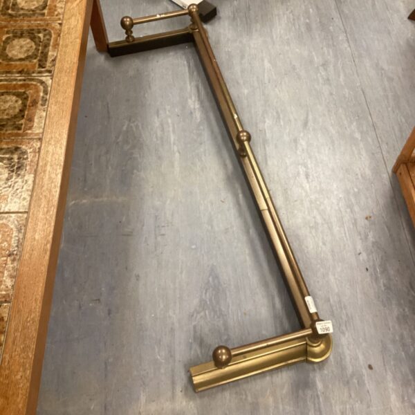Vintage brass fireplace rod with decorative turned details.