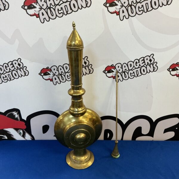 Vintage brass holy water bottle with candle snuffer, antique religious item.