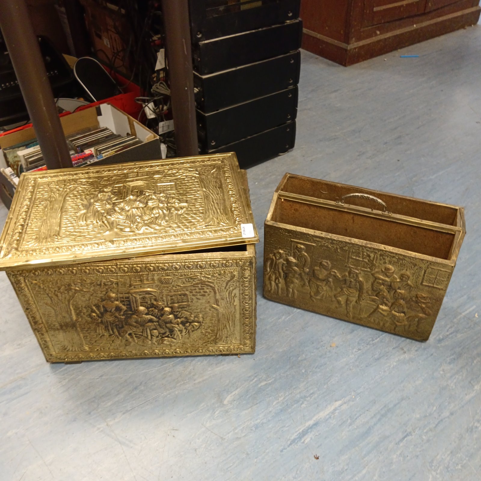 Vintage brass log box with embossed floral design.