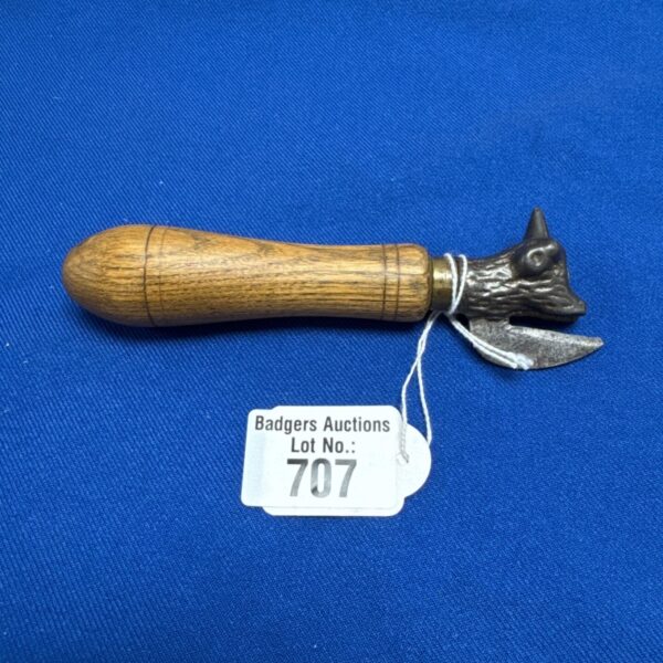 Vintage bully beef can opener with wooden handle.