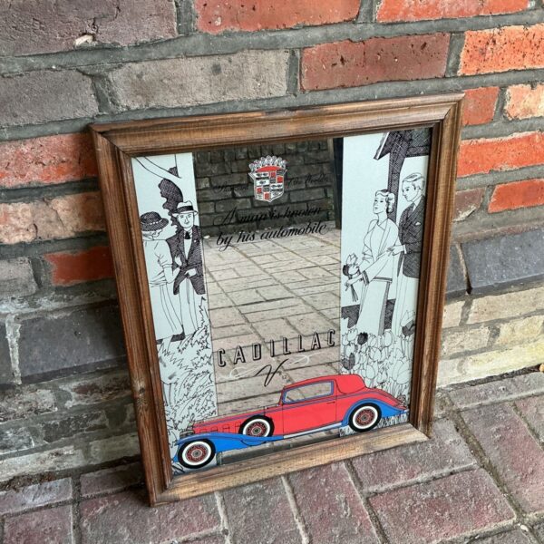 Vintage Cadillac mirror with the phrase "A man is known by his automobile".