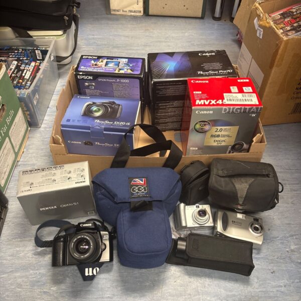 Vintage camera lot featuring Pentax, Canon, and a digital camcorder.