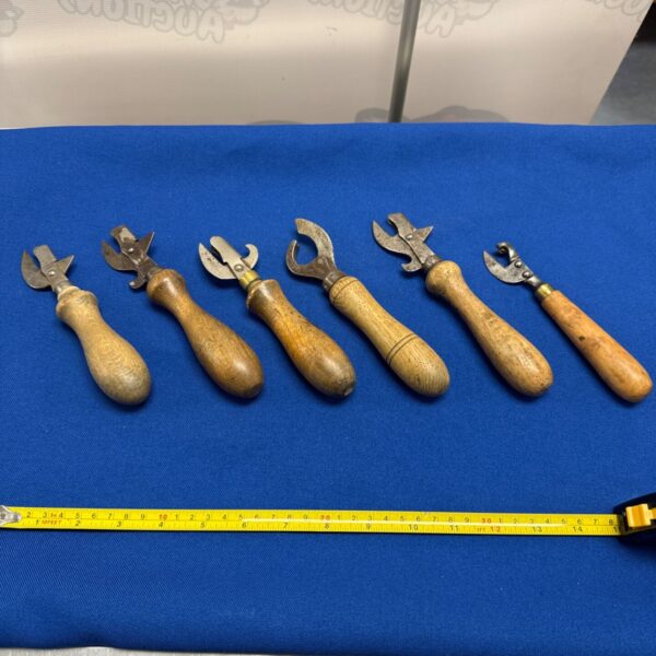 Lot of six vintage can openers with wooden handles.