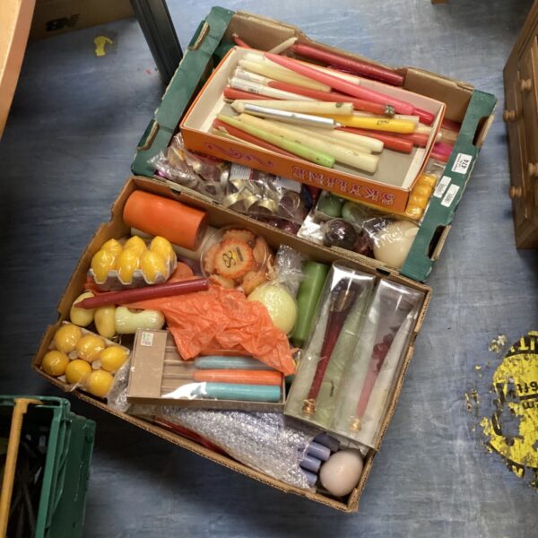 Vintage crate filled with colourful wax candles, a collectible lot.