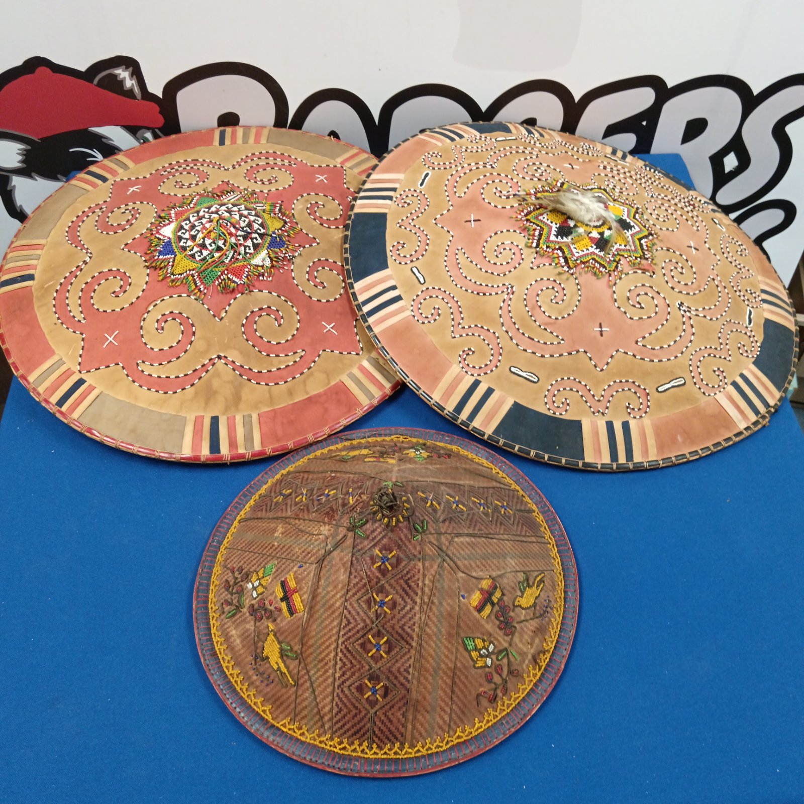 Group of three vintage Chinese beadwork hats with colourful designs.