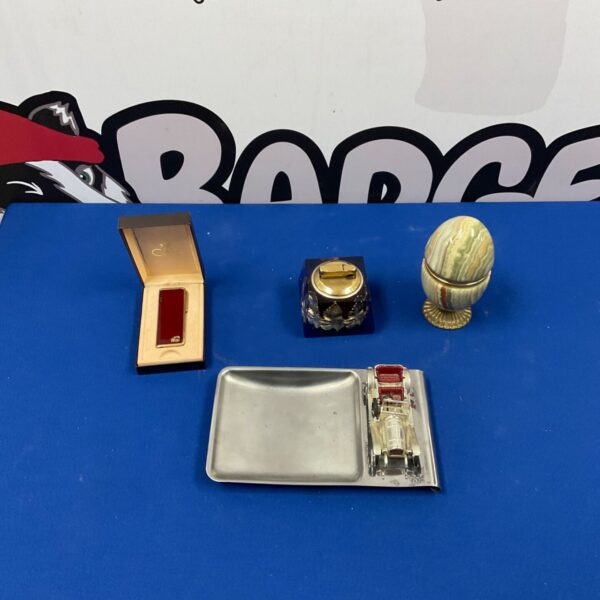 Vintage cigarette lighters including a Colibri lighter in a selection.