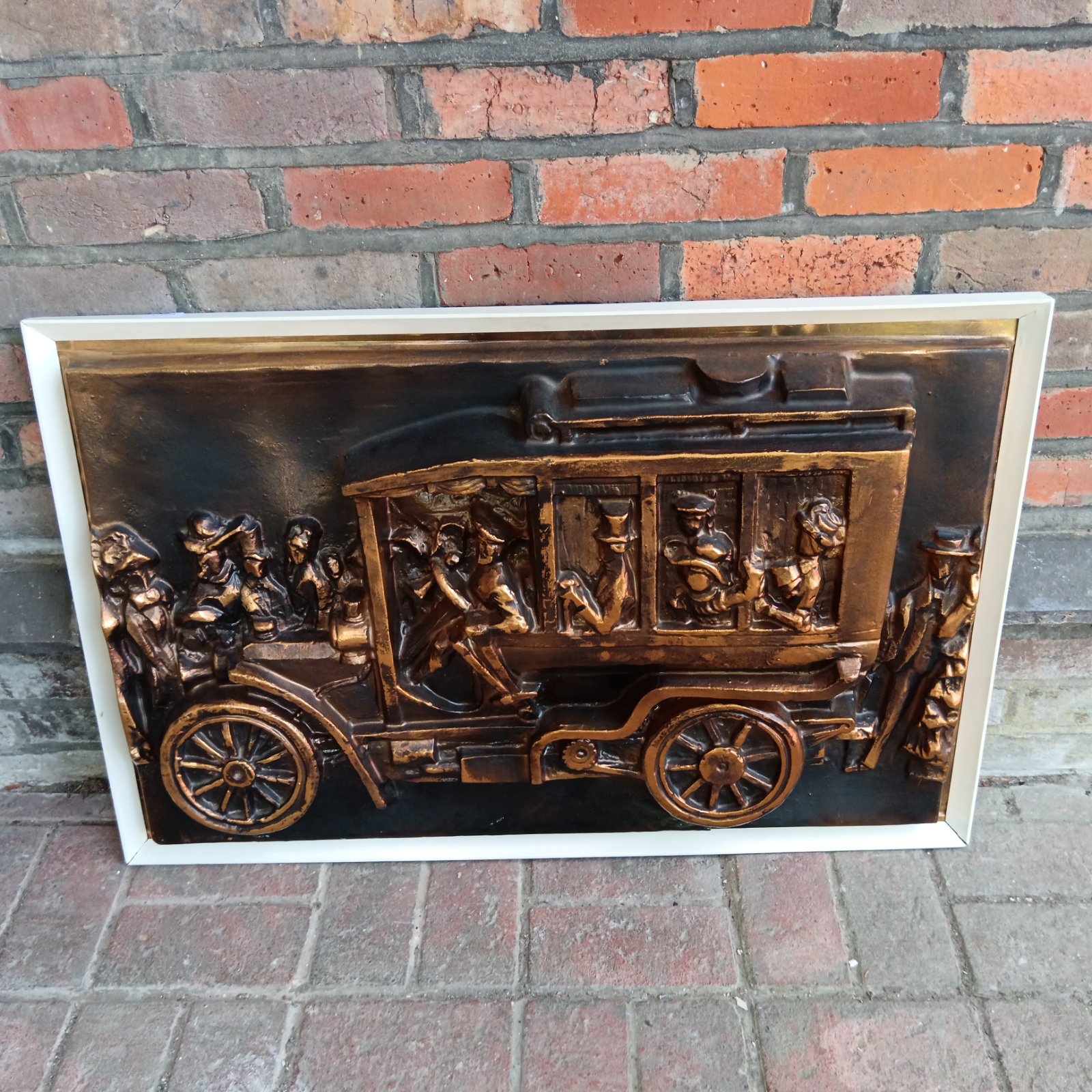 Detailed vintage coach wall art sculpture with passengers.