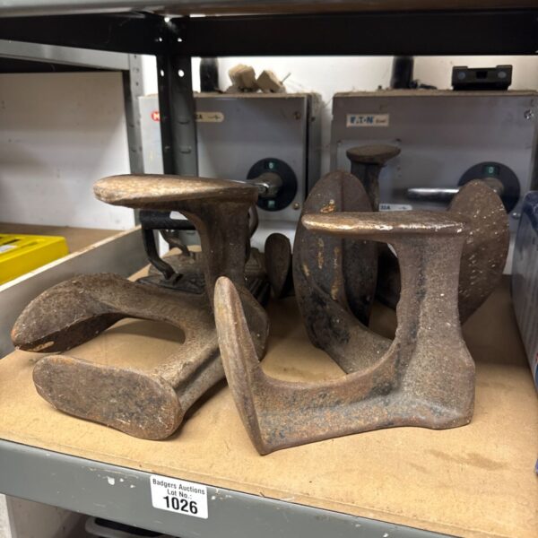 Vintage cobblers lasts and flat irons for leatherworking and shoemaking.