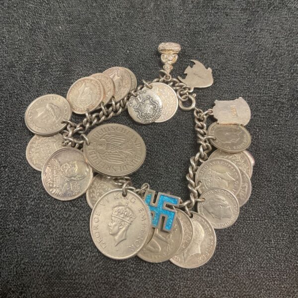 Vintage silver coin charm bracelet with various international coins.