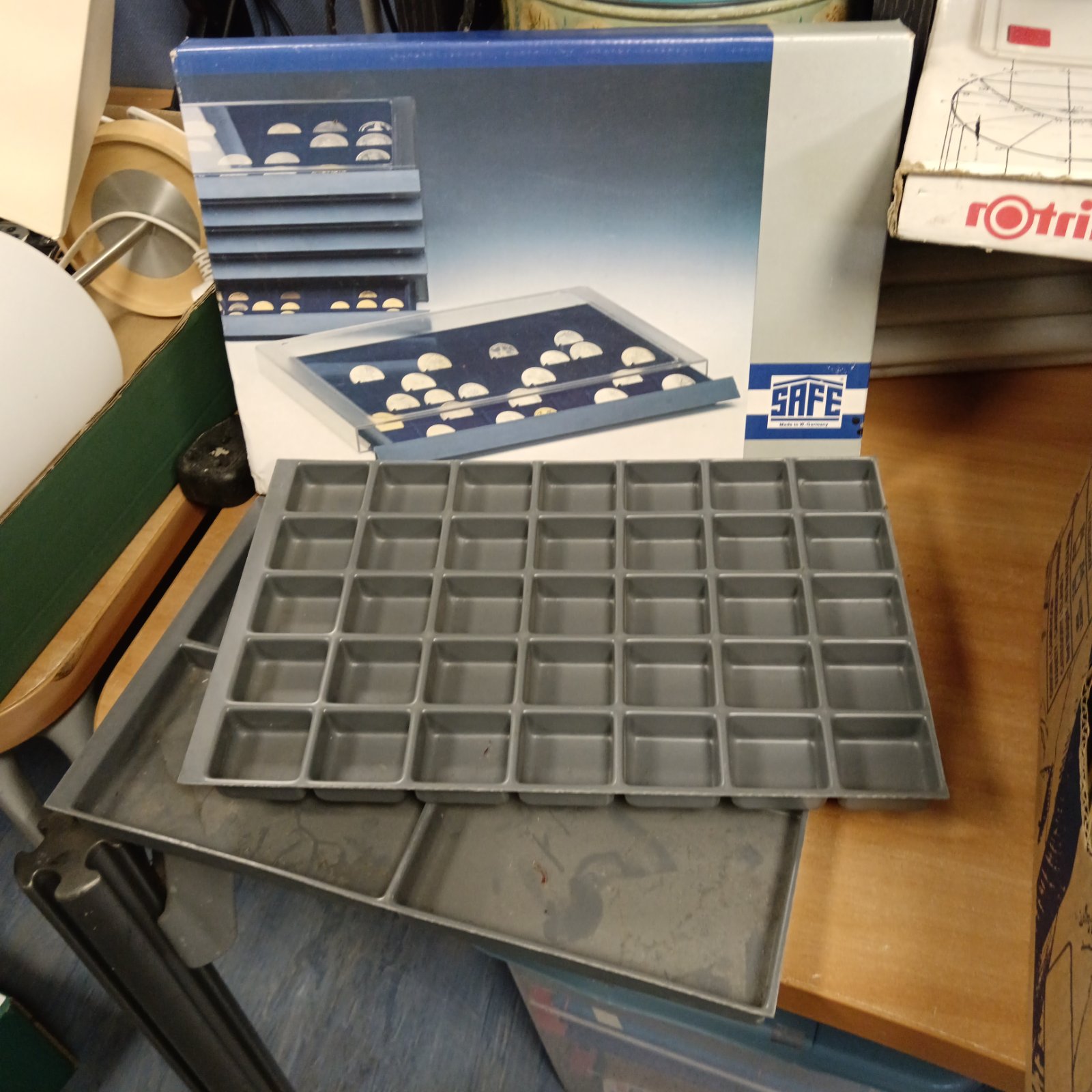 Vintage coin sorting trays for currency organization and collecting.