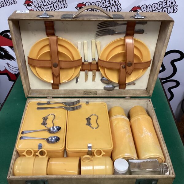Open vintage Coracle picnic set showing yellow melamine dishes.