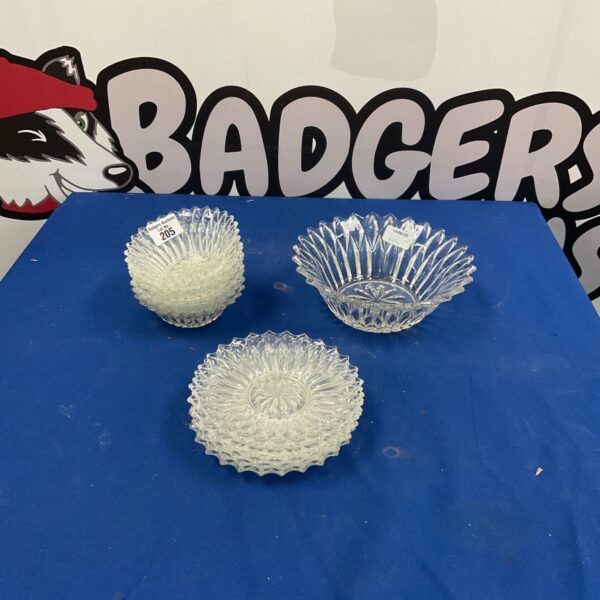 Vintage cut glass bowls displayed on a patterned surface.